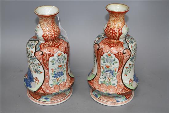 A pair of Japanese enamelled porcelain huqqa base vases, decorated with figures, height 25cm